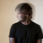 Blurry image showing a man shaking dealing with trauma