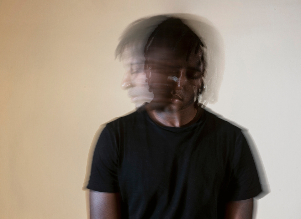 Blurry image showing a man shaking dealing with trauma