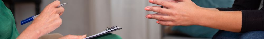 A pair of hands in a therapy office depicting cognitive behavioral