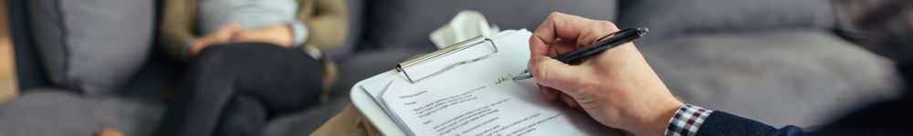 therapist writing down notes during a psychotherapy session