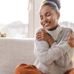 woman hugging herself in a showing of self-love