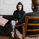 Therapist performing acceptance and commitment therapy on a client
