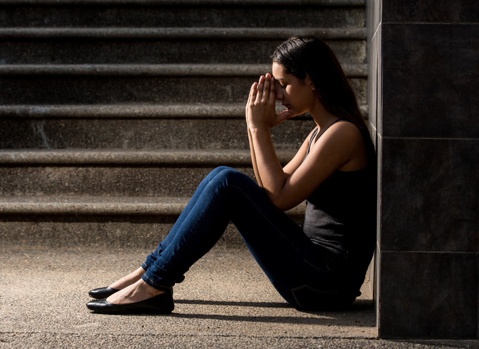 Woman sitting down upset, dealing with her body image issues