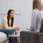 Young adult woman sitting in a therapy session