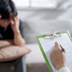 young man meets with a therapist to see if his PTSD is a mood disorder