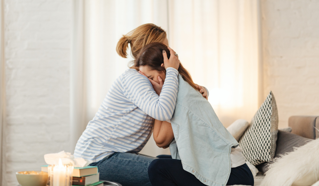 Mother comforting her daughter suffering from bulimia