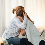 Mother comforting her daughter suffering from bulimia