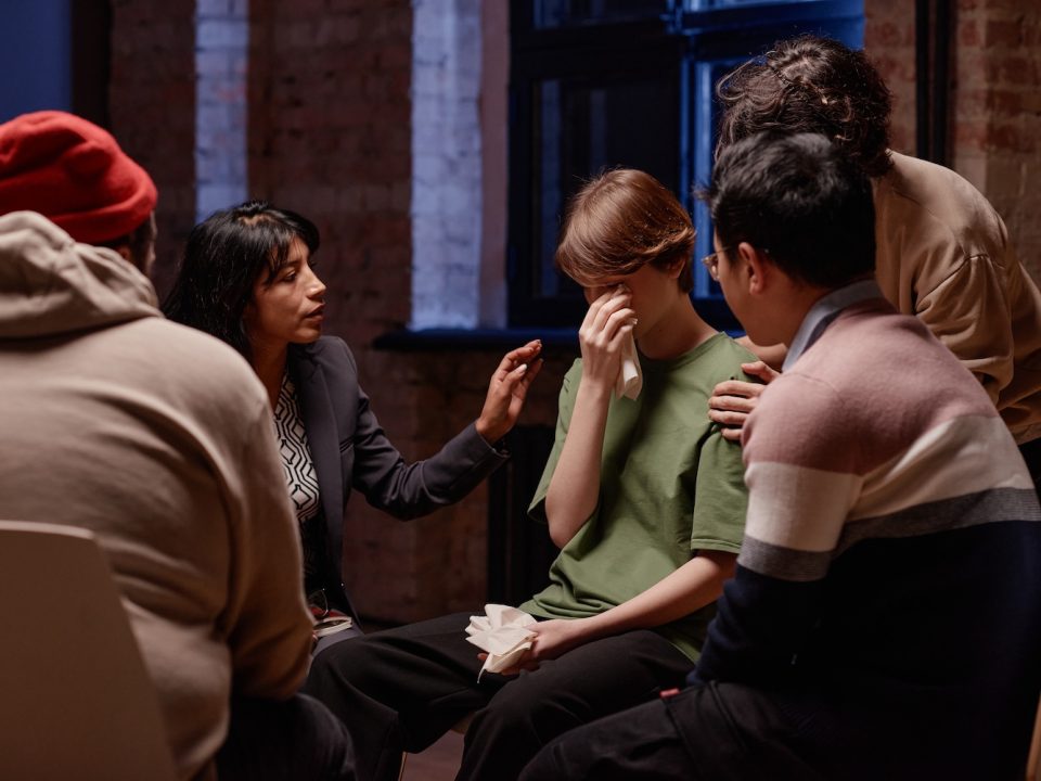 woman being comforted in group therapy