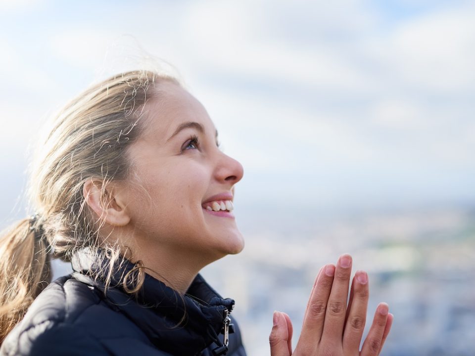 Hopeful woman looking up to the sky after overcoming an eating disorder relapse