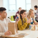 High school teens sitting in the cafeteria