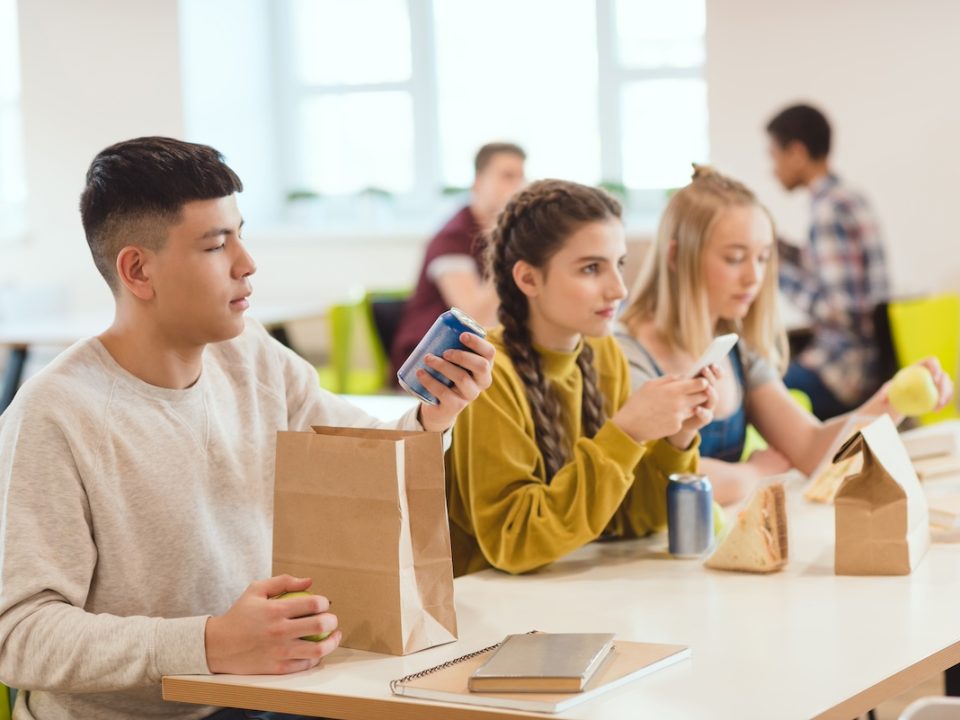 High school teens sitting in the cafeteria