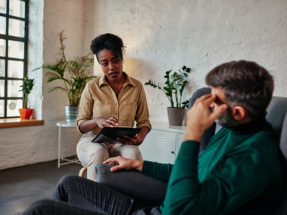 Psychologist in a session with an adult male client