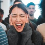 Woman standing and screaming in the midst of an anxiety attack