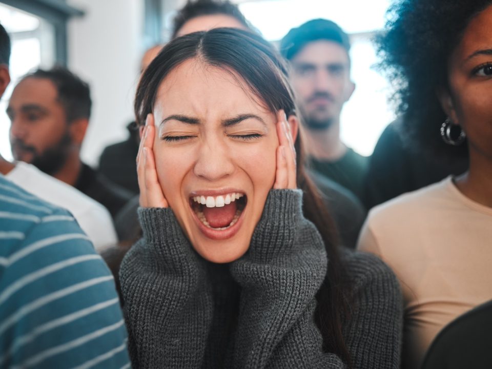 Woman standing and screaming in the midst of an anxiety attack