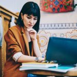 young female looking intently at her computer