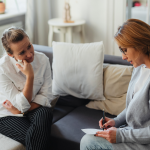 woman sitting with her therapist undergoing one of ACT, CBT, DBT