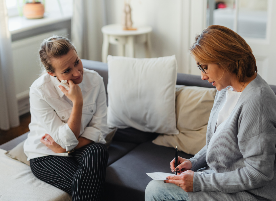 woman sitting with her therapist undergoing one of ACT, CBT, DBT