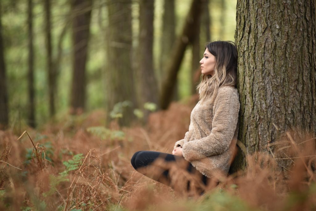 Woman sitting alone in the woods