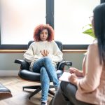 young African American woman talking with a therapist about anorexia and mental health